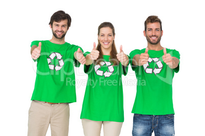 People in recycling symbol t-shirts gesturing thumbs up
