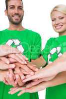 People in recycling symbol t-shirts with hands together
