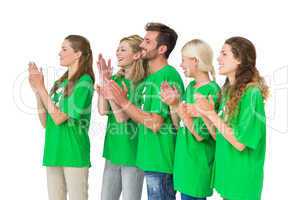 People in recycling symbol t-shirts clapping hands