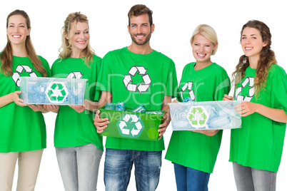 People in recycling symbol t-shirts carrying boxes