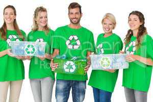 People in recycling symbol t-shirts carrying boxes