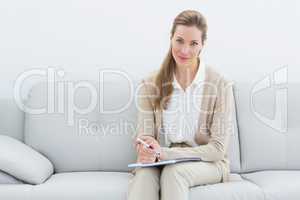 Smiling female financial adviser sitting on sofa