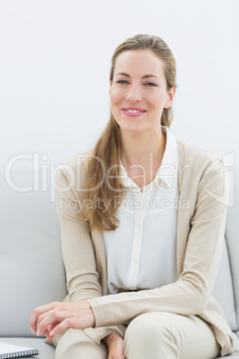 Smiling female financial adviser sitting on sofa