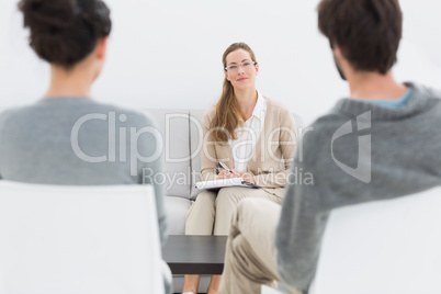 Female financial adviser in meeting with young couple