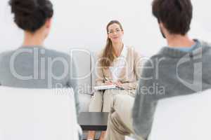 Female financial adviser in meeting with young couple