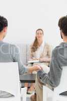 Blurred female financial adviser in meeting with couple