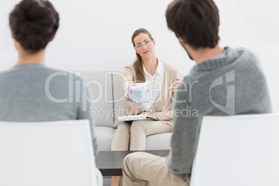 Female financial adviser in meeting with couple