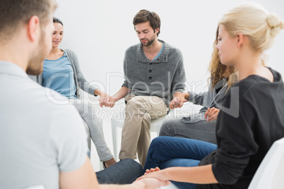 Group therapy in session sitting in a circle