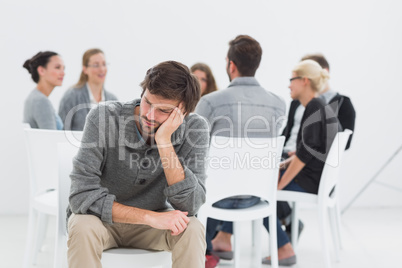 Therapy in session in circle while man in foreground