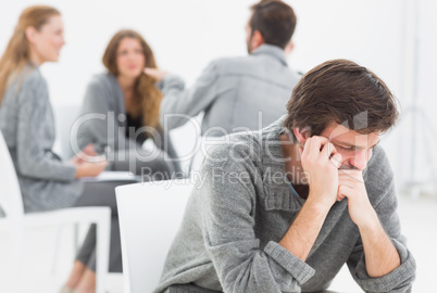 Therapy in session sitting in a circle while man in foreground