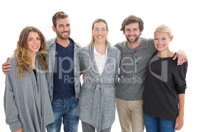 Group portrait of happy people standing with arms around