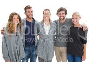 Group portrait of happy people standing with arms around
