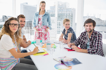 Casual business people around conference table in office