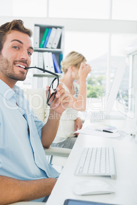 Smiling casual young couple working on computer