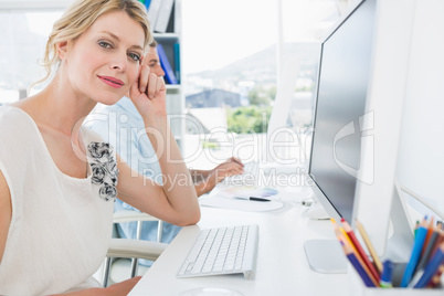 Smiling casual young couple working on computers