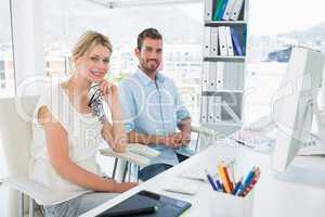 Portrait of smiling casual young couple with computer