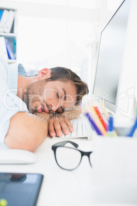 Male artist with head resting on keyboard