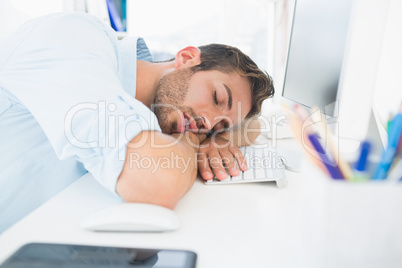 Male artist with head resting on keyboard