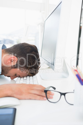 Male artist with head resting on keyboard