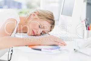 Female artist with head resting on keyboard
