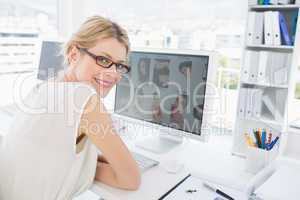 Female photo editor working on computer