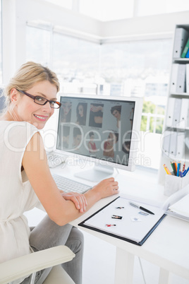 Side view portrait of a female photo editor working on computer