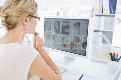 Rear view of a female photo editor working on computer