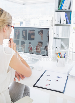 Rear view of a female photo editor working on computer