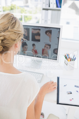 Rear view of a female photo editor working on computer