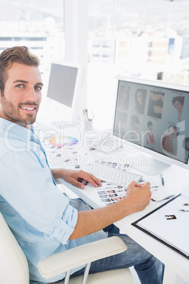 Side view portrait of a male photo editor working on computer