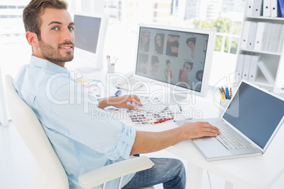 Male photo editor working on computer