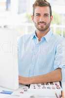 Portrait of a smiling young man using computer