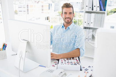 Portrait of a male photo editor working on computer