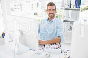 Portrait of a male photo editor working on computer