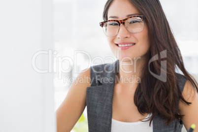 Portrait of a smiling young woman using computer