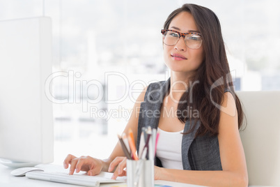 Portrait of a smiling young woman using computer
