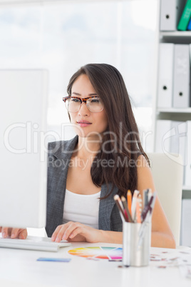 Concentrated woman using computer in office