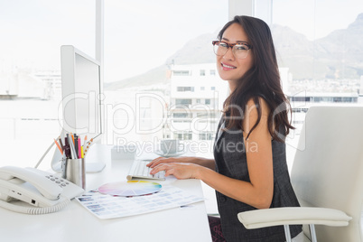 Female photo editor working on computer
