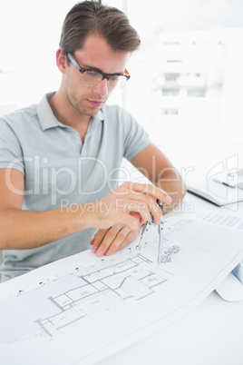 Man using compass on design