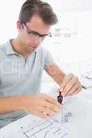 Man using compass on design