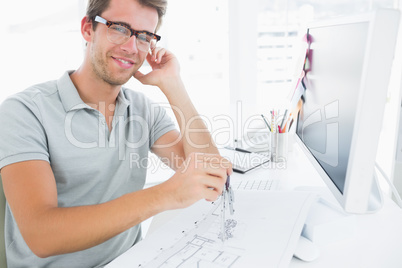 Man using compass on design