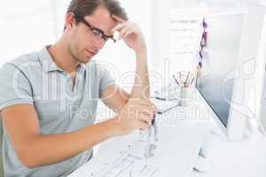 Man using compass on design