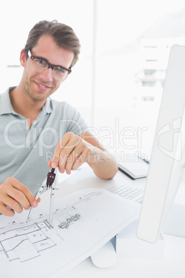 Man using compass on design