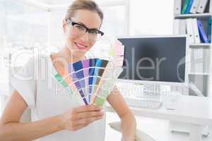 Female photo editor holding colors in office