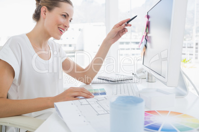 Side view of female photo editor working on computer