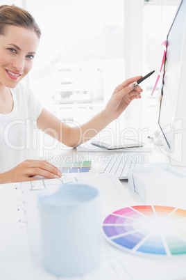 Side view portrait of female photo editor working on computer