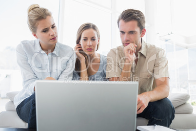 Three young people working on computer