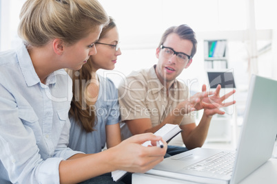 Three young people working on computer