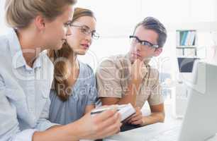 Three young people working on computer