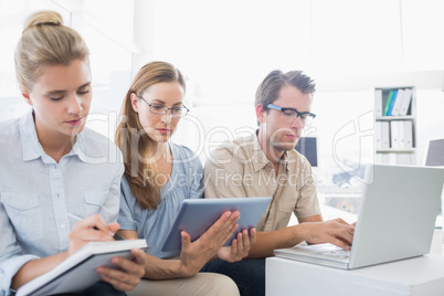 Concentrated three young people in office